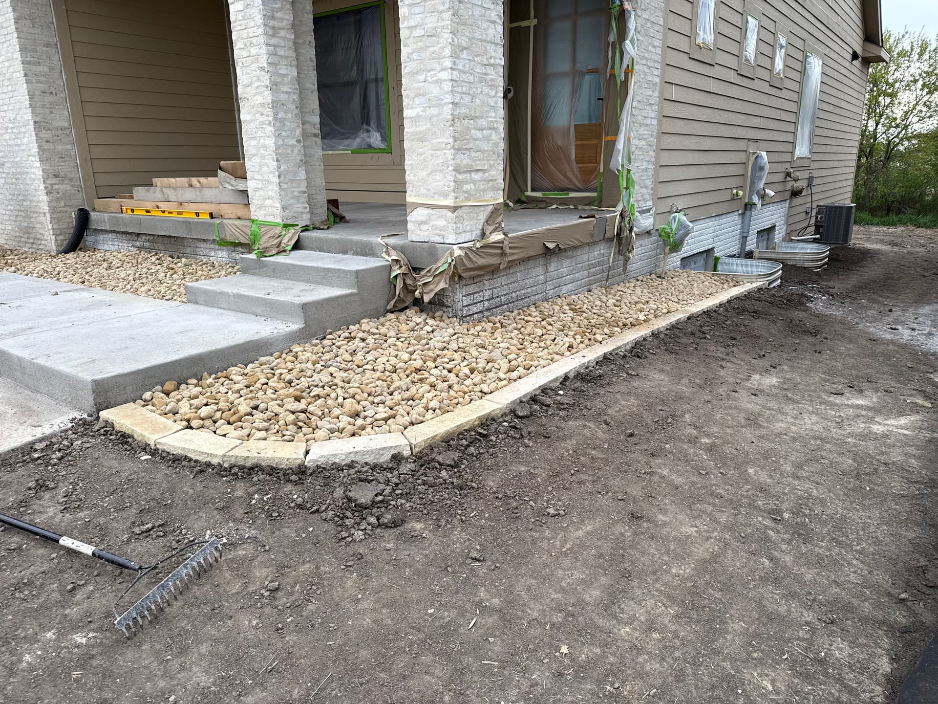 Gallery photos for New Construction Landscape Work with Iowa Buff and River Rock: Image #4